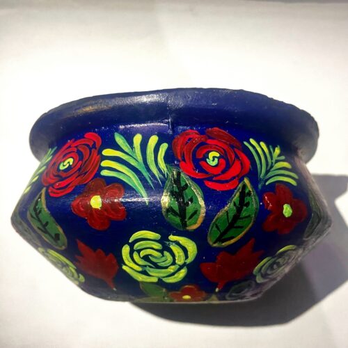 The clay pot or bowl is made by local potters and the Papermachie floral design is made by artist Jasia Nisar.